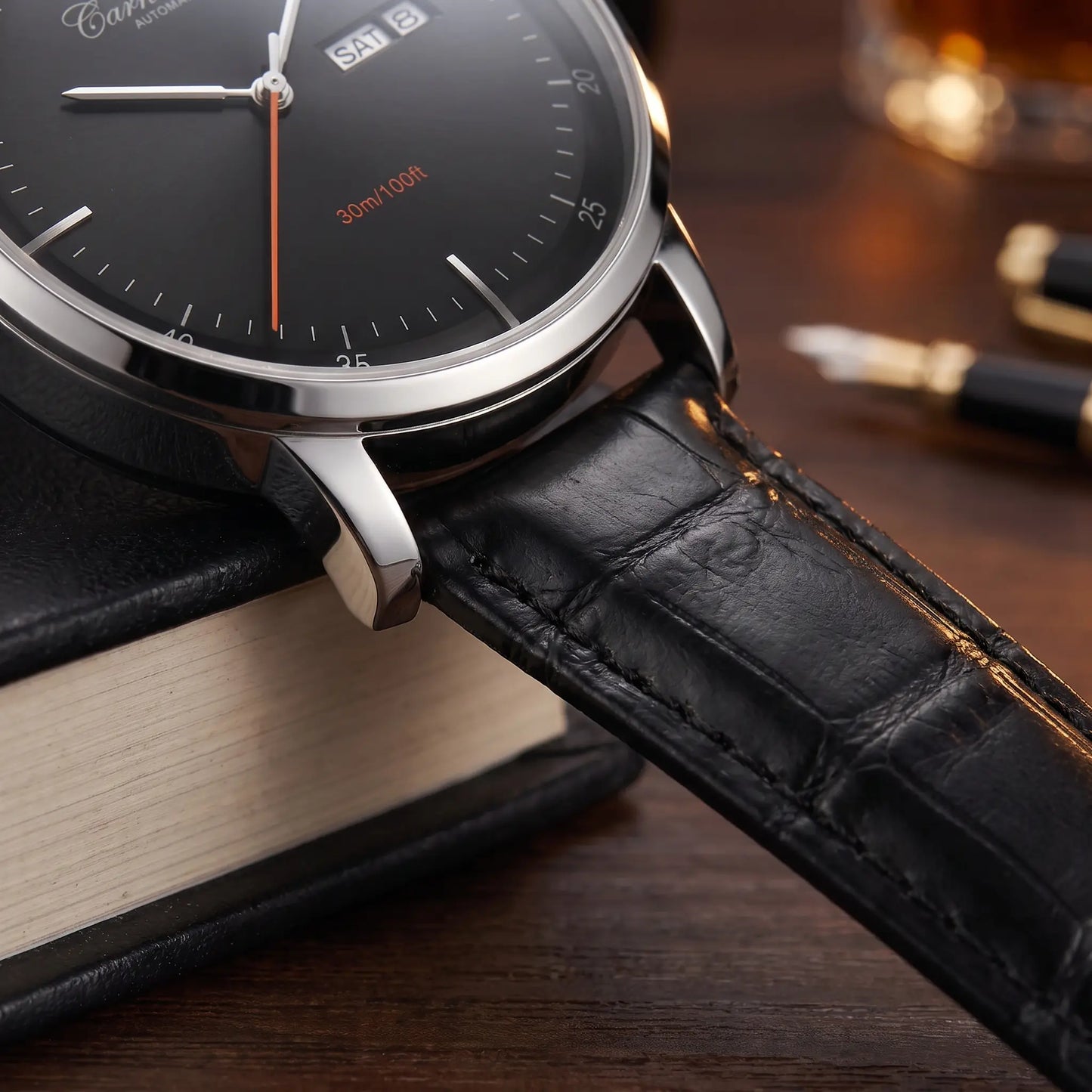 Close up of the textured leather strap and polished lug on the watch