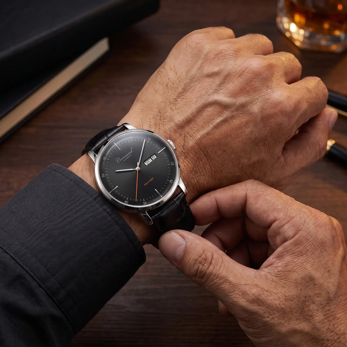 Man fastening the slim leather watch onto his wrist