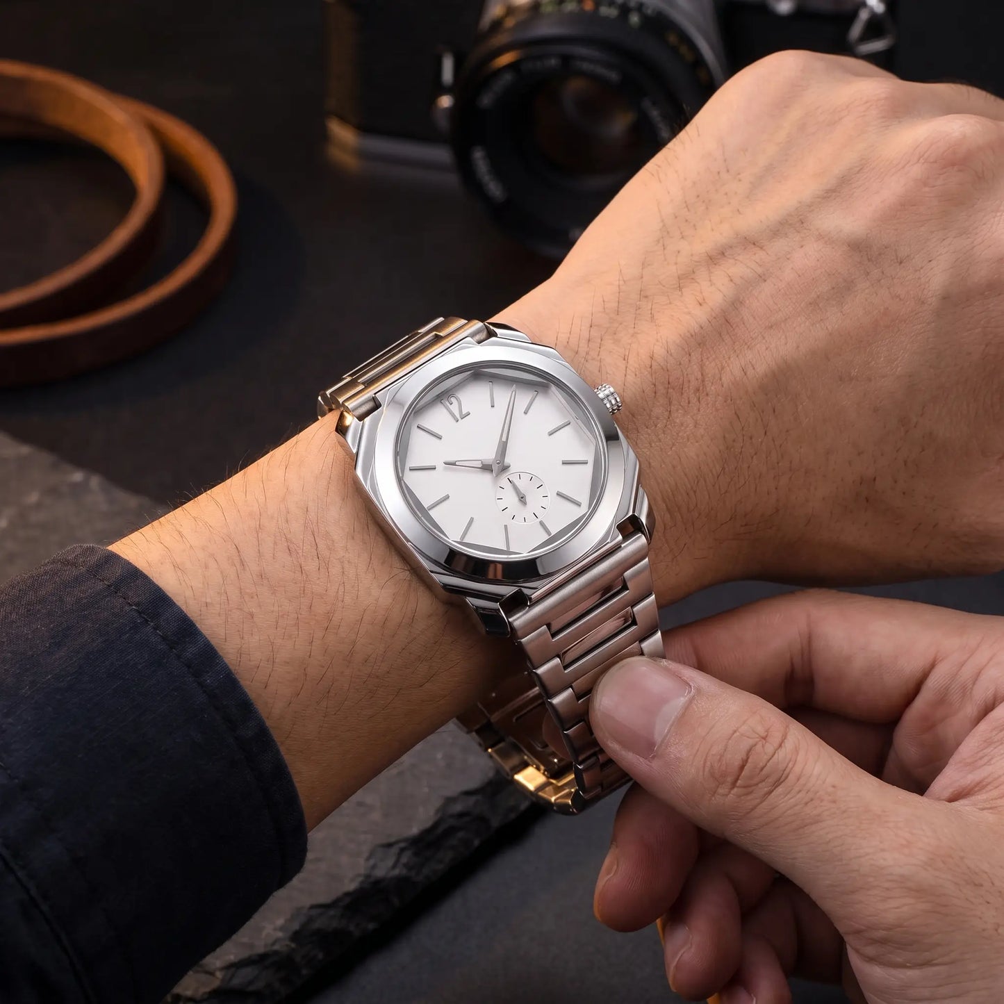 SLIM OCTAGON WATCH worn on the wrist, clasp being fastened - slim octagonal steel watch in use
