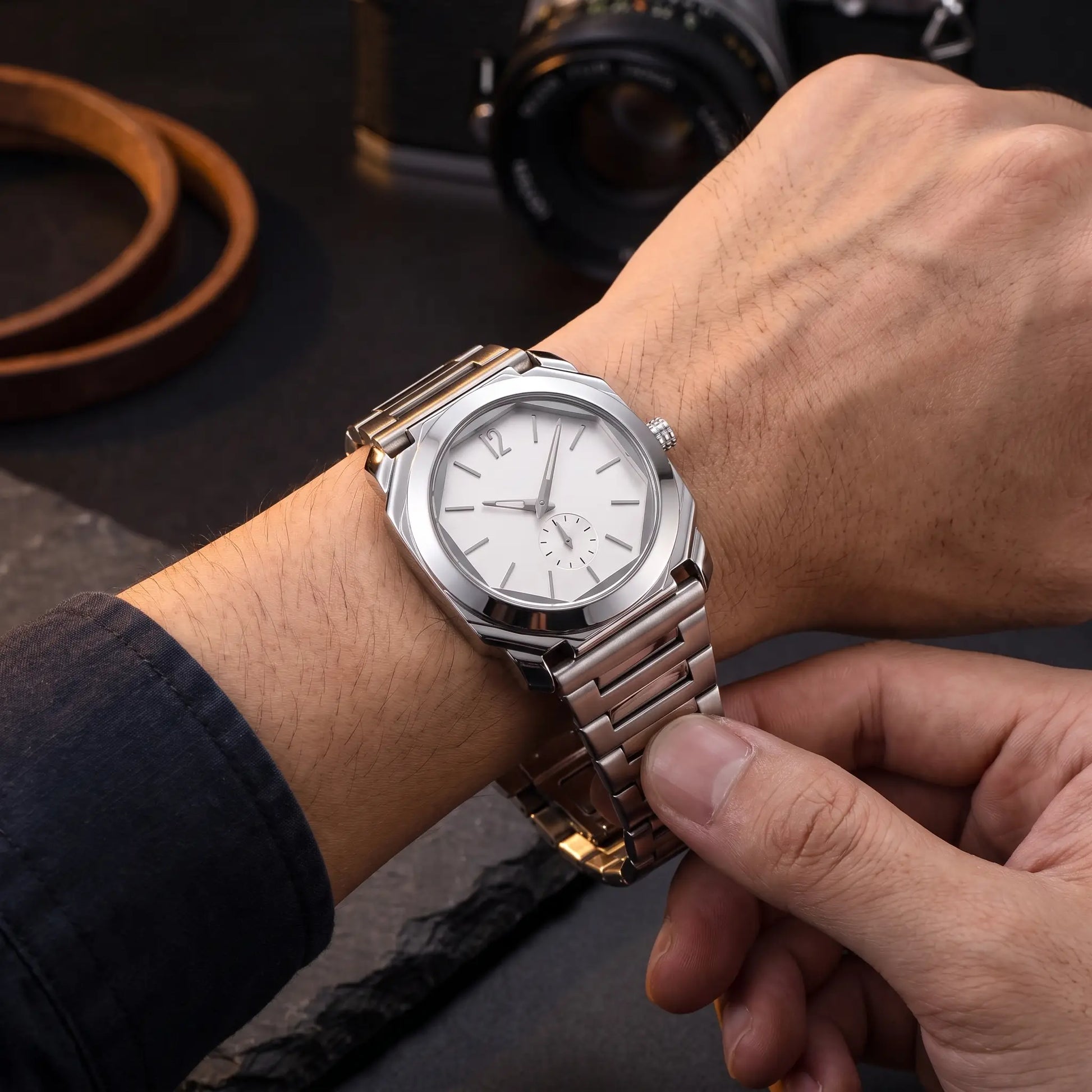 SLIM OCTAGON WATCH worn on the wrist, clasp being fastened - slim octagonal steel watch in use