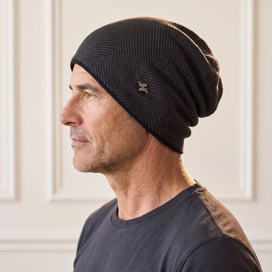 Black slouch knit beanie with fine herringbone knit, fleece lined men's winter beanie worn in side profile