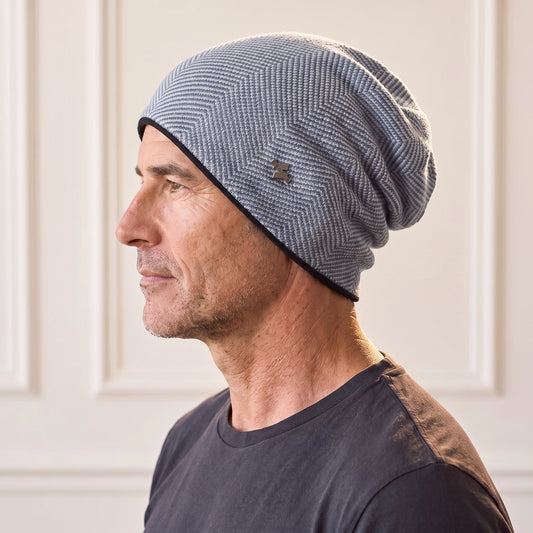 Navy slouch knit beanie in light grey-blue herringbone knit with navy fleece lining, men's winter beanie worn in side profile