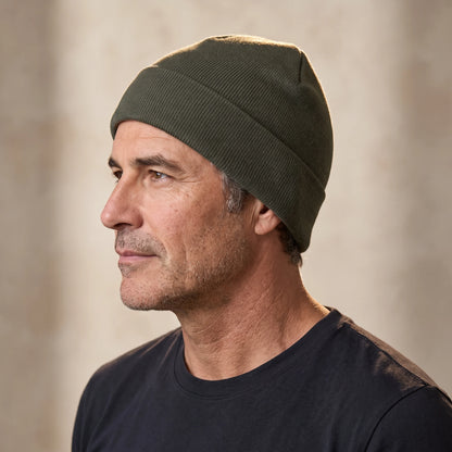 Smooth knit beanie in green, close fit pulled down over the ears, men's winter beanie shown in side profile