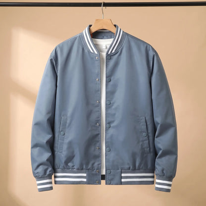 Men's blue snap-front baseball bomber jacket with white-striped rib collar, cuffs and hem on a wooden hanger