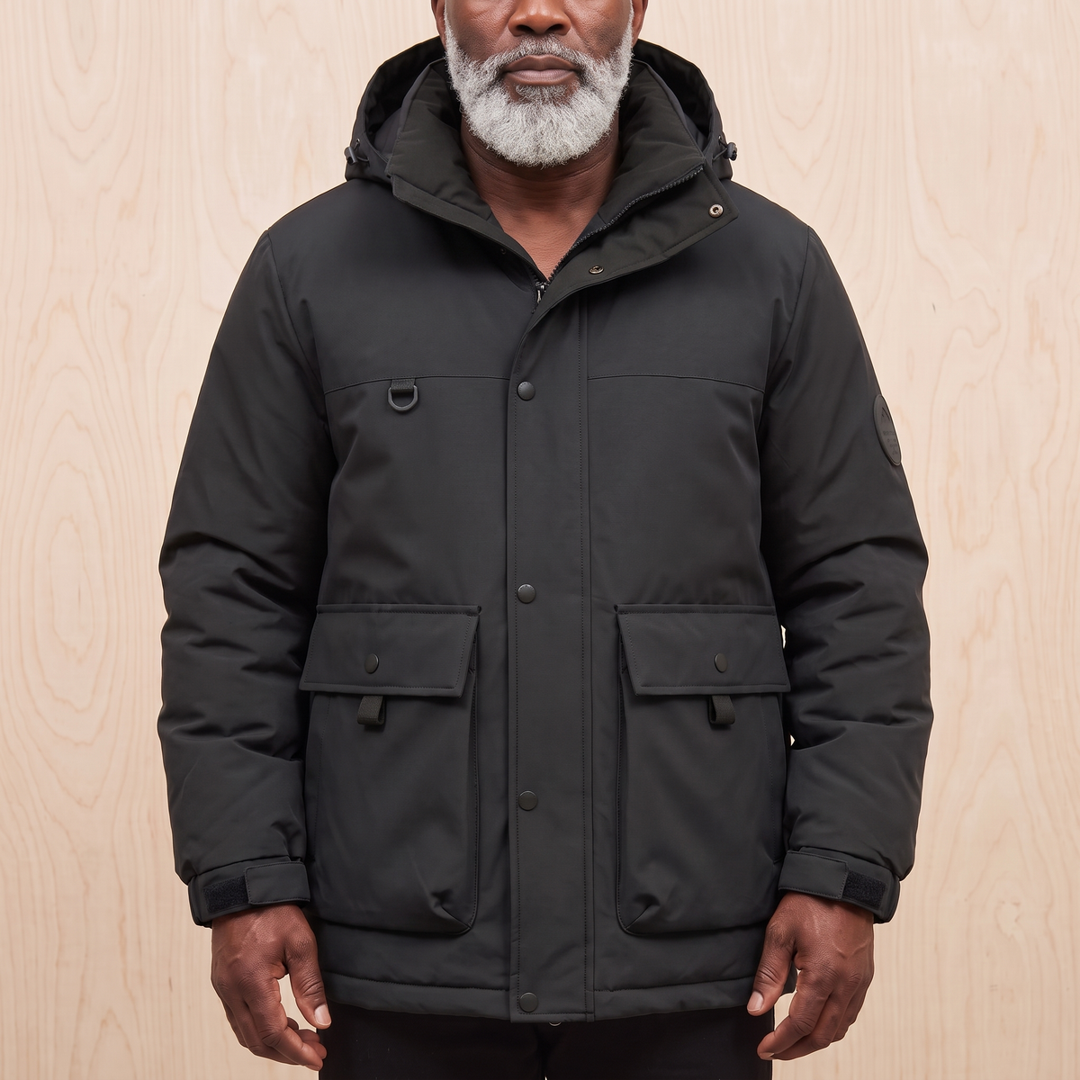Men's black hooded padded parka with snap storm front
