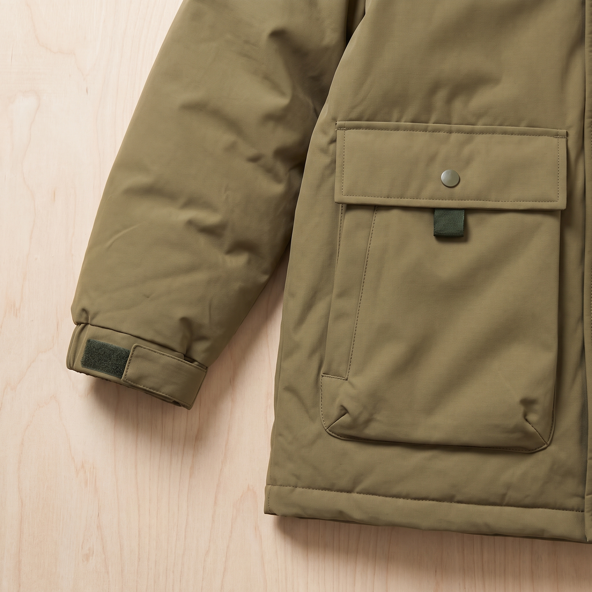 Close detail of the parka cuff tab and lower flap pocket