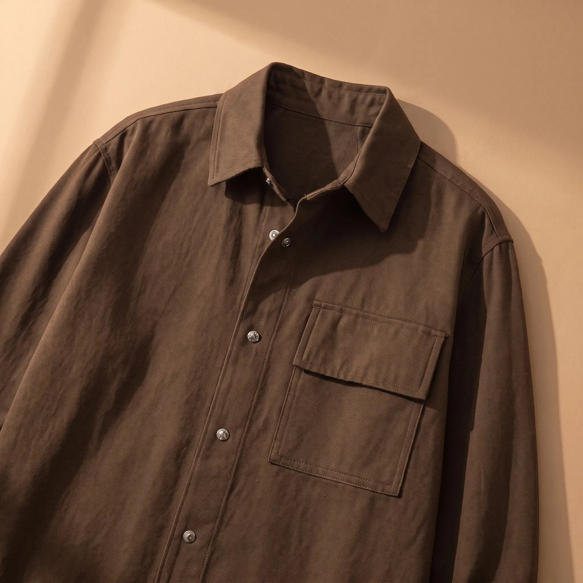 Snap Front Shirt in Brown laid flat, collar and chest pocket close-up