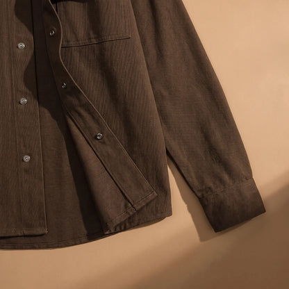 Snap Front Shirt in Brown laid flat, cuff and snap front hem close-up
