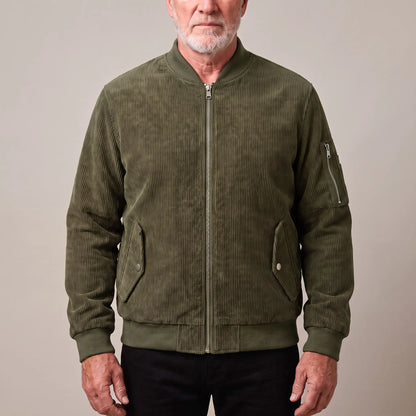 Men's green corduroy bomber jacket with ribbed collar and snap-flap pockets, worn zipped