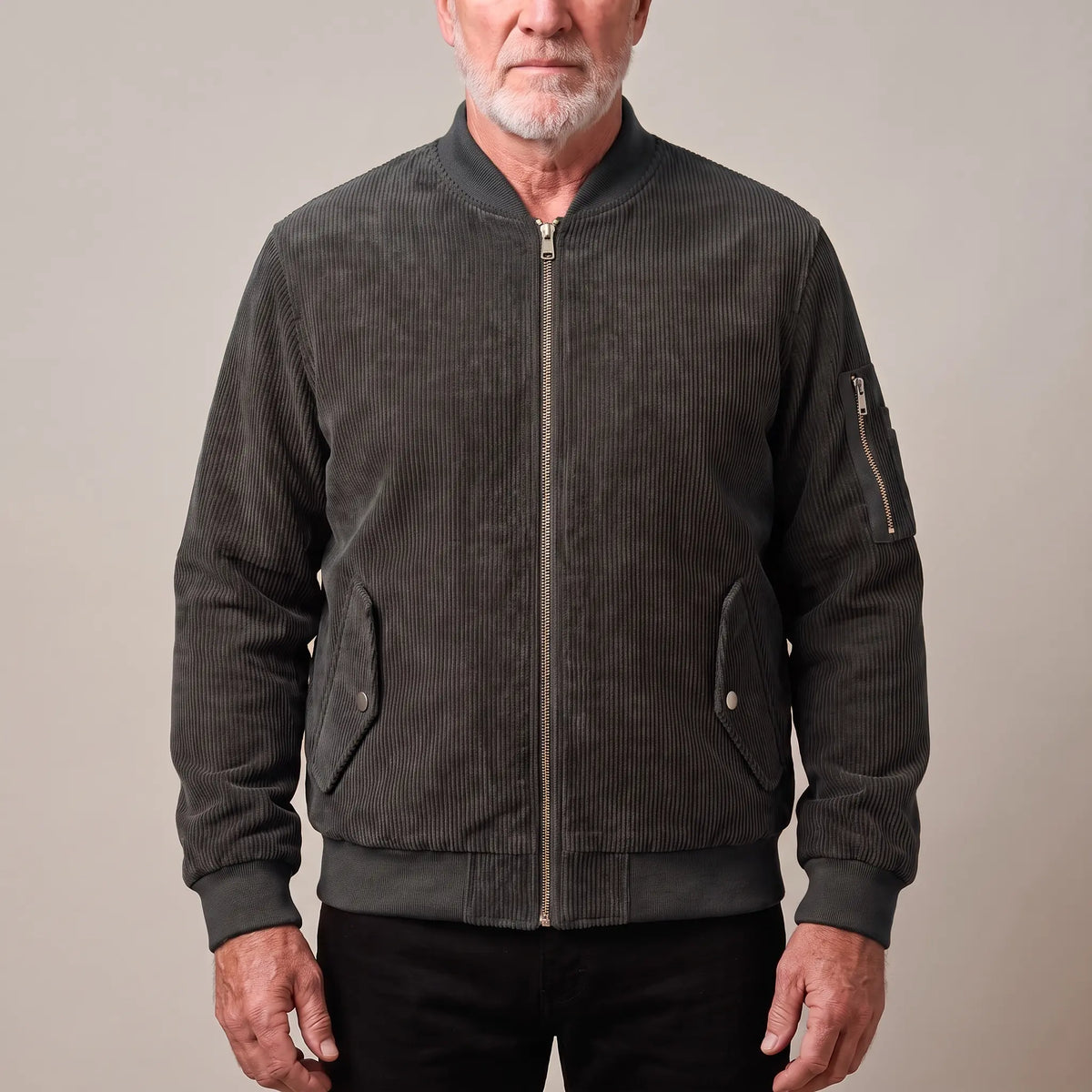 Men's grey corduroy bomber jacket with ribbed collar and snap-flap pockets, worn zipped
