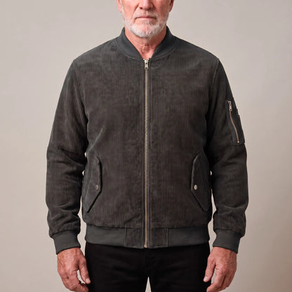 Men's grey corduroy bomber jacket with ribbed collar and snap-flap pockets, worn zipped