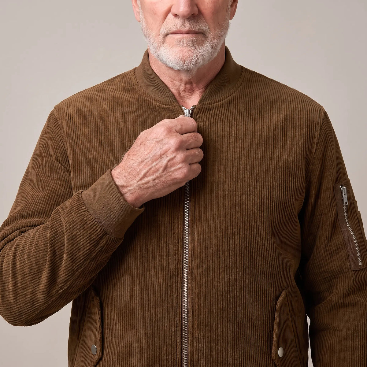 Man zipping up the brown snap pocket bomber