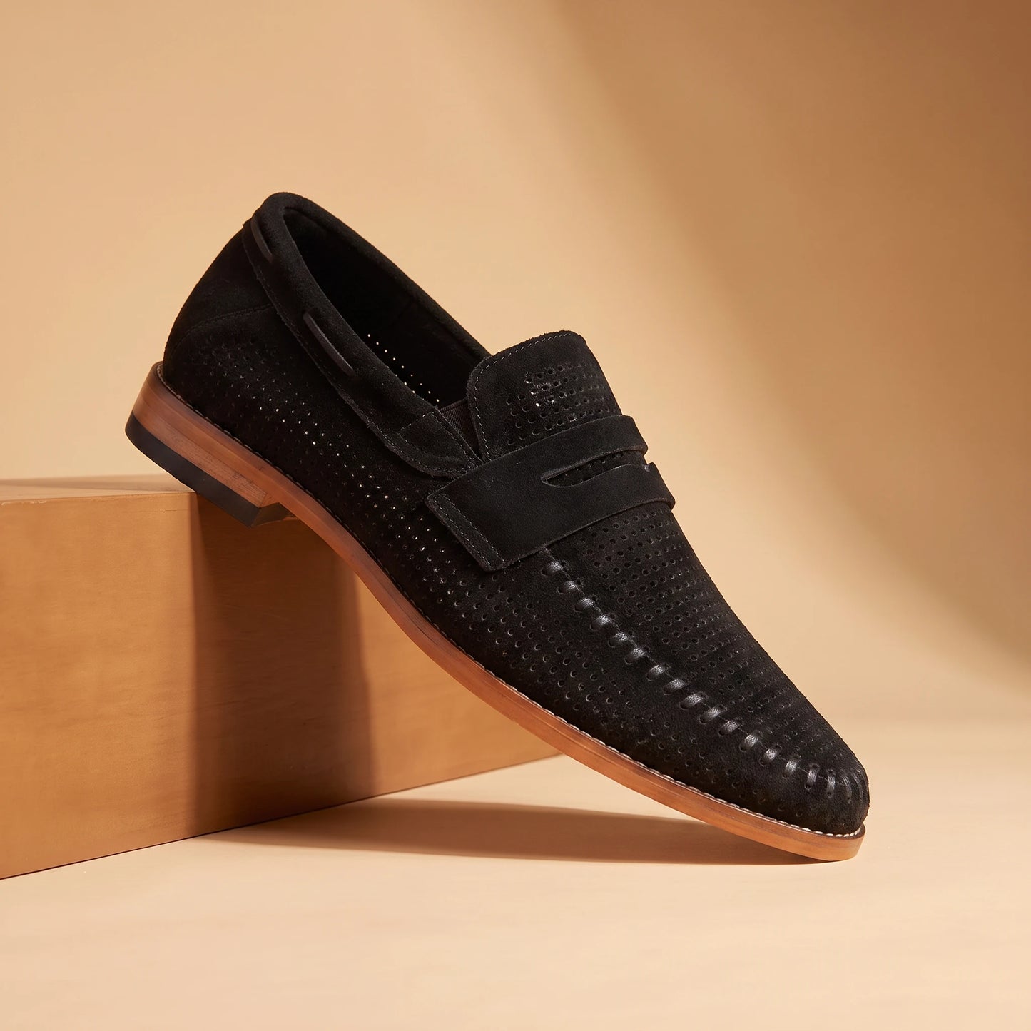 SOFT MOC LOAFERS in black, perforated suede penny loafer, pedestal hero