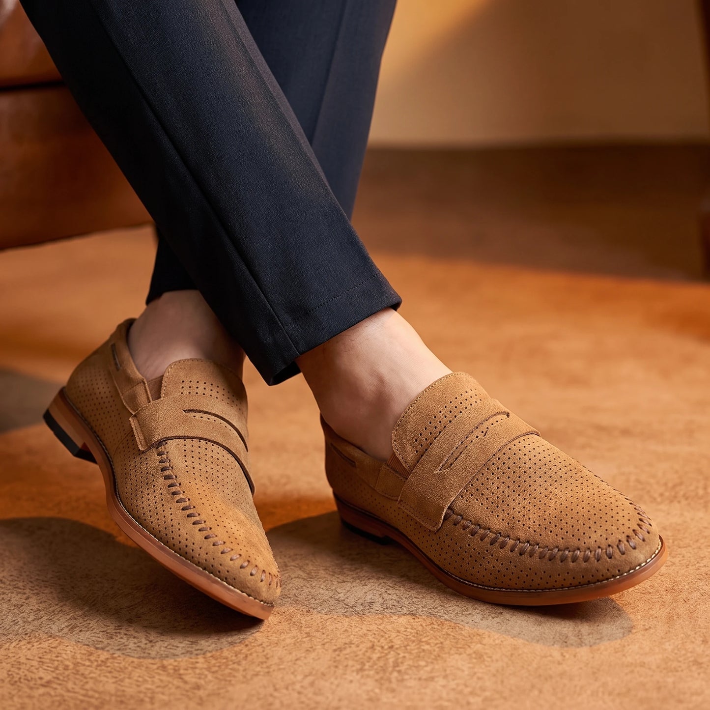 Man wearing SOFT MOC LOAFERS in brown, crossed-ankles with dark trousers