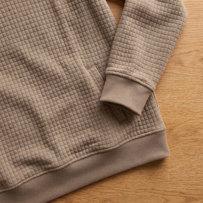 Close detail of SOFT WAFFLE PULLOVER showing the ribbed cuff, slash pocket and hem
