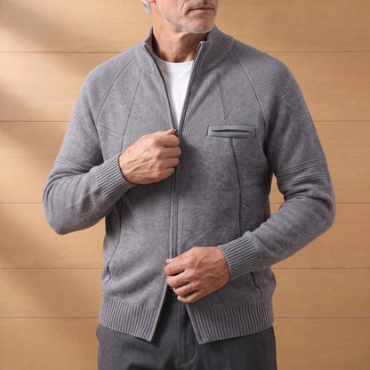 Man zipping up the STAND COLLAR CARDIGAN in dark gray over a white tee