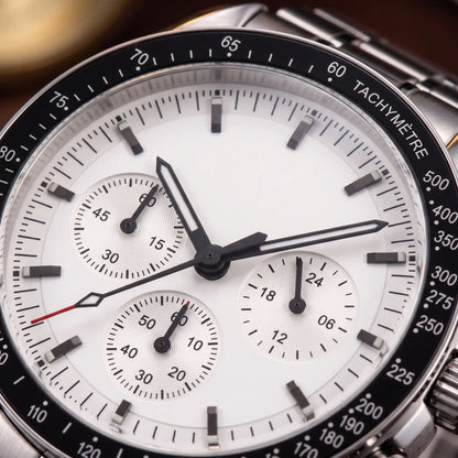 STEEL CHRONOGRAPH WATCH dial close-up - white dial with three sub-dials, baton markers and black tachymetre bezel