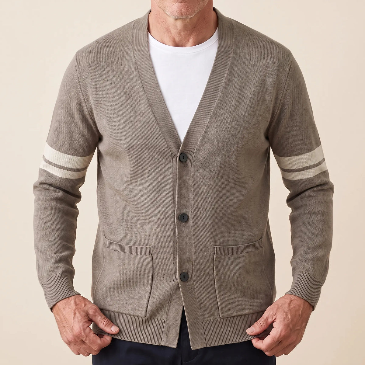 Man wearing khaki striped V-neck knit cardigan buttoned over a white tee