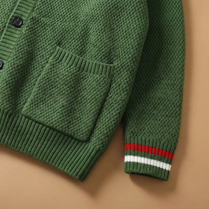 Close-up of the Stripe Cuff Cardigan in green showing the patch pocket, ribbed hem and red and white striped cuff