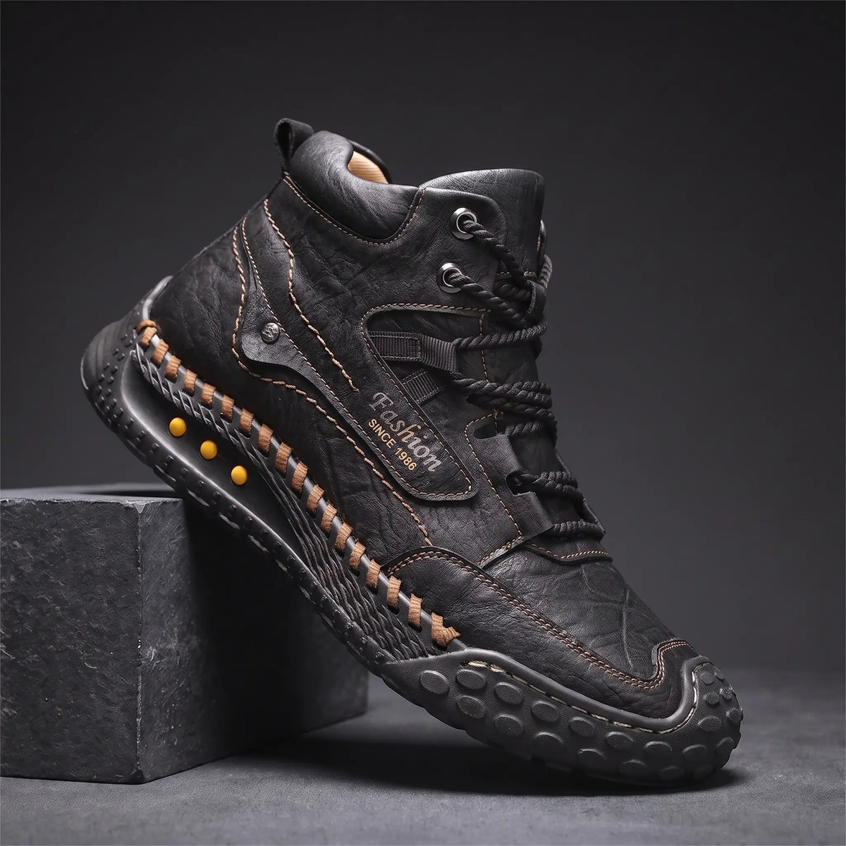 STUDDED SOLE BOOTS in black, men's mid-high lace-up boot in washed creased leather with hand-stitched sole edge and studded rubber outsole