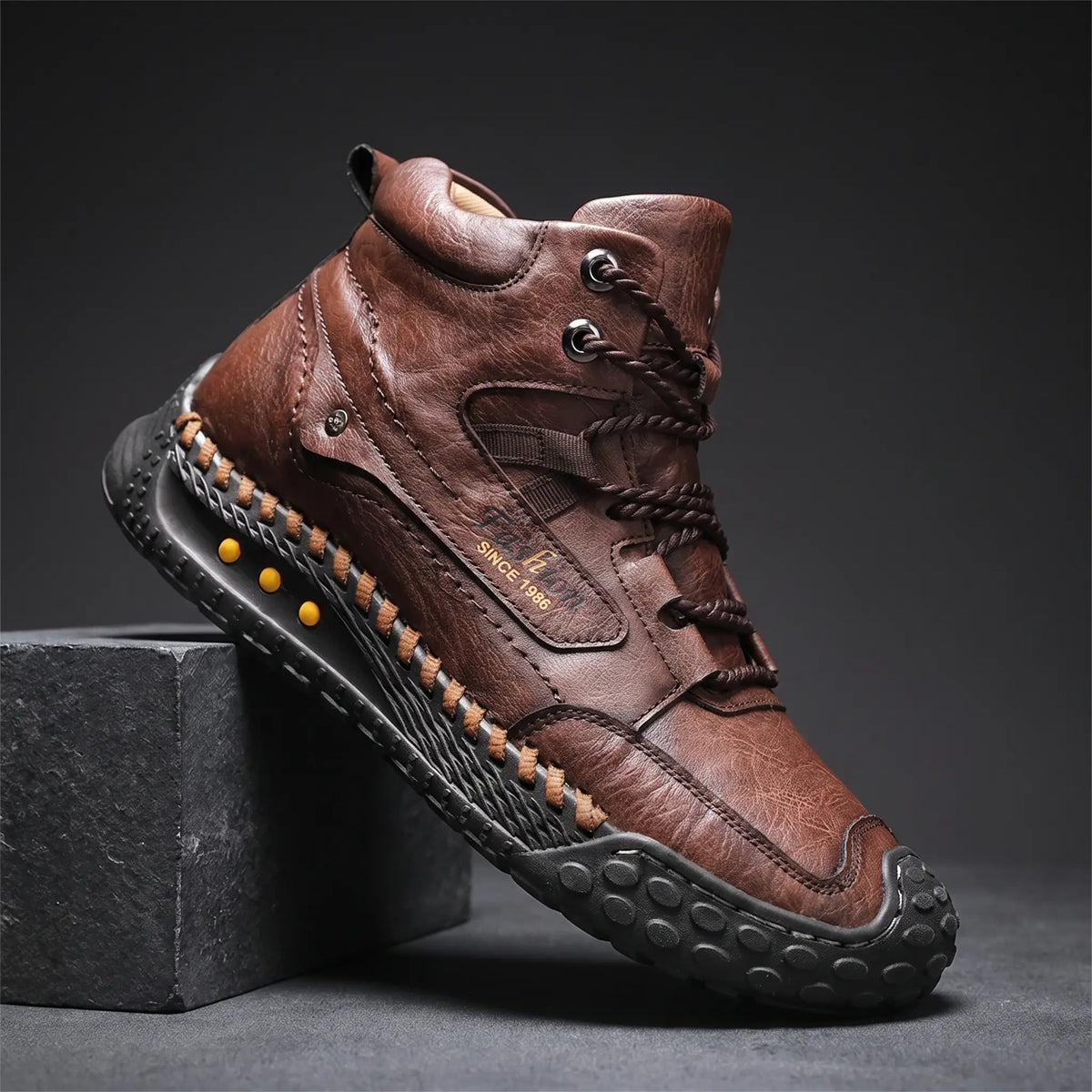 STUDDED SOLE BOOTS in brown, men's mid-high lace-up boot in washed creased leather with hand-stitched sole edge and studded rubber outsole