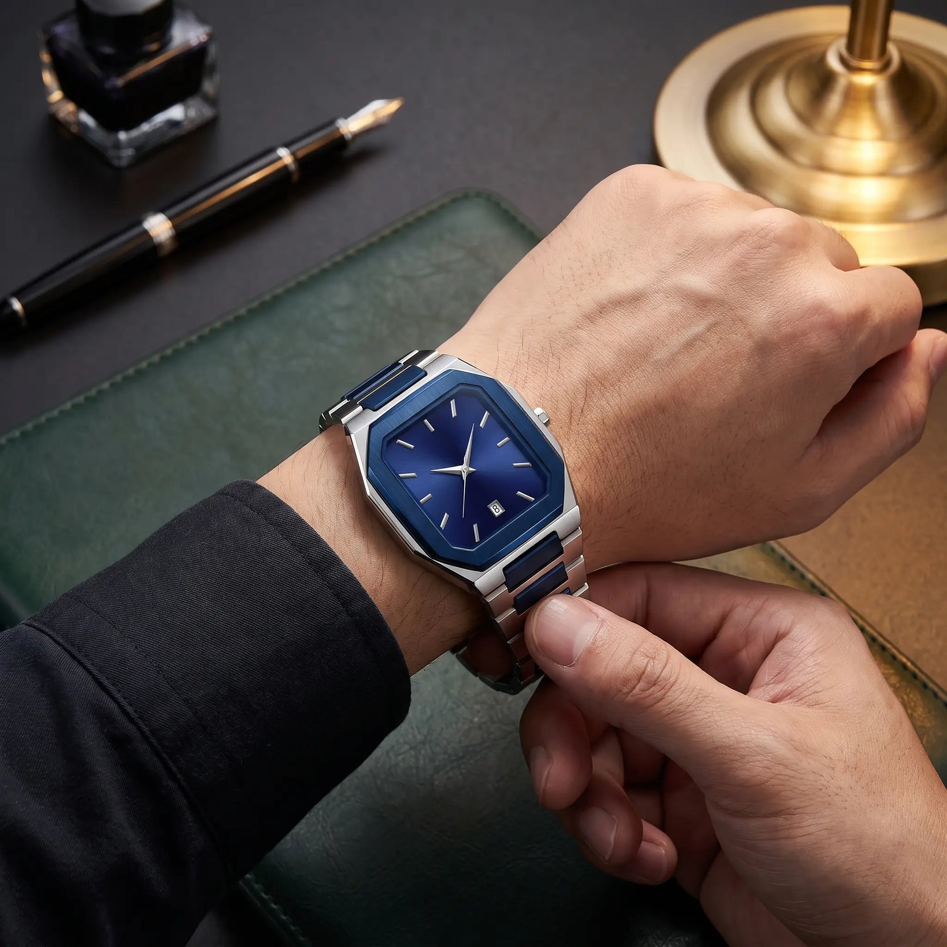 SUNBURST DIAL WATCH worn on the wrist - fastening the two-tone steel bracelet clasp