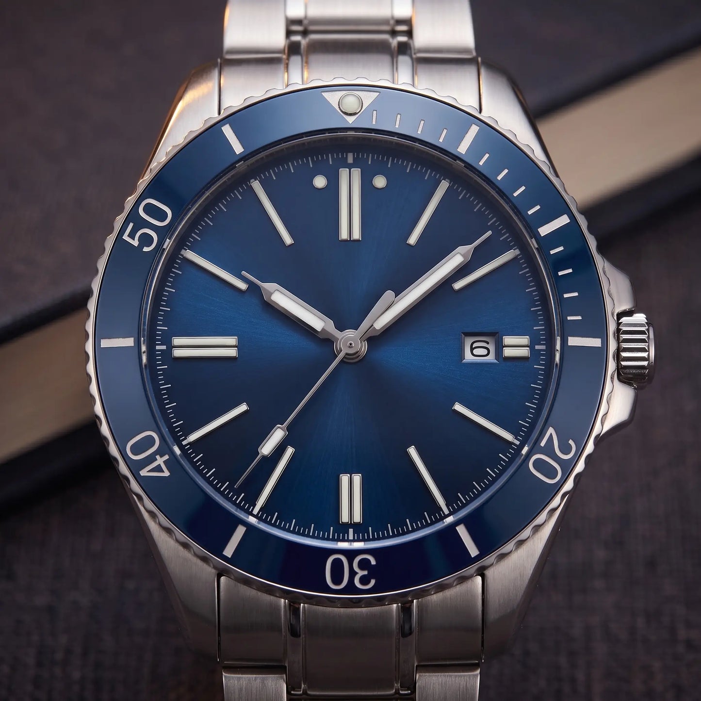 SUNRAY DIAL WATCH dial close-up - blue sunray dial with luminous baton markers, date window and rotating bezel