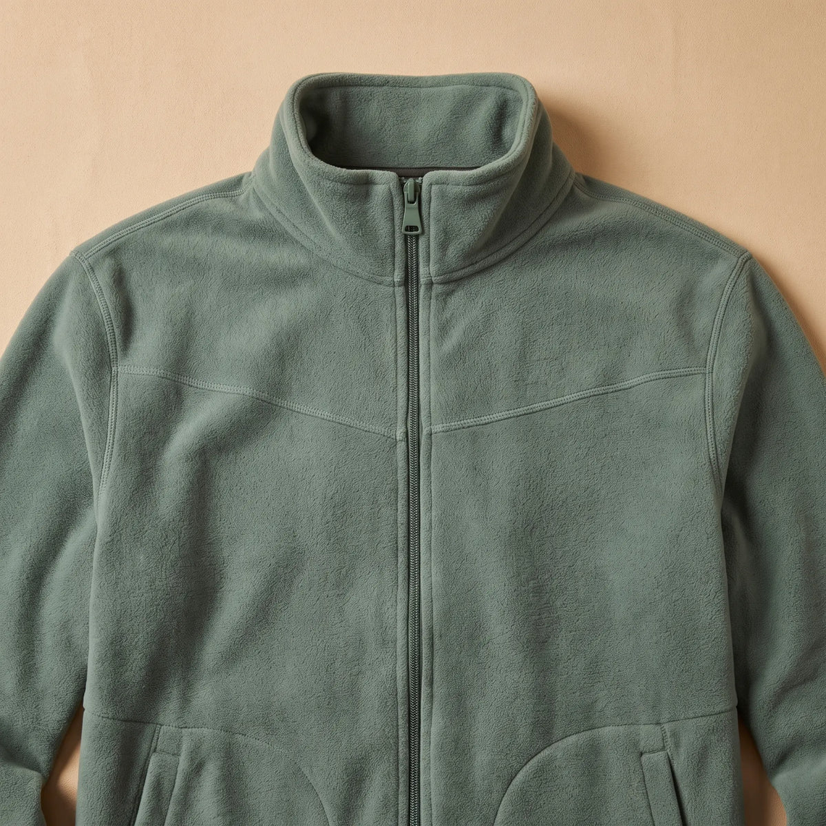 Close detail of TALL COLLAR FLEECE showing the tall stand collar and full-length zip
