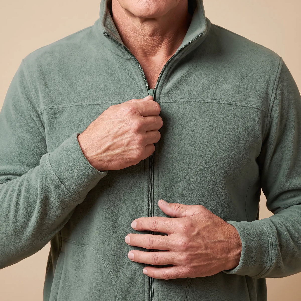 Man zipping up the TALL COLLAR FLEECE, close view of the front