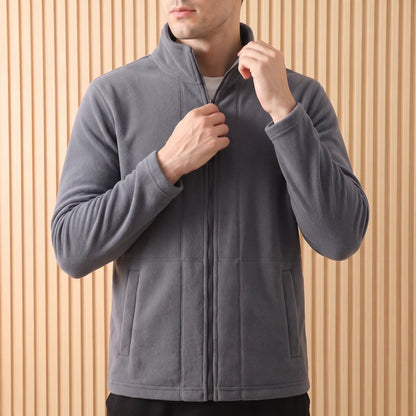 THICK POLAR FLEECE in Grey worn - man drawing the full-length front zip up on the grey polar fleece jacket