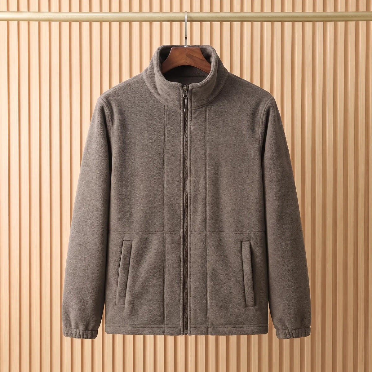 THICK POLAR FLEECE in Khaki - polar fleece jacket with tall stand collar and full front zip, on a wooden hanger