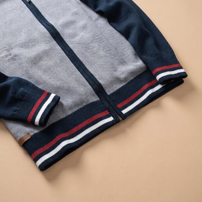 Close-up of men's zip knit cardigan ribbed hem and cuff with red and white stripes
