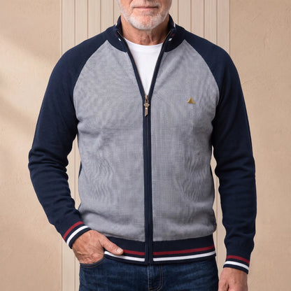 Man wearing navy blue tipped zip knit cardigan over a white tee with jeans