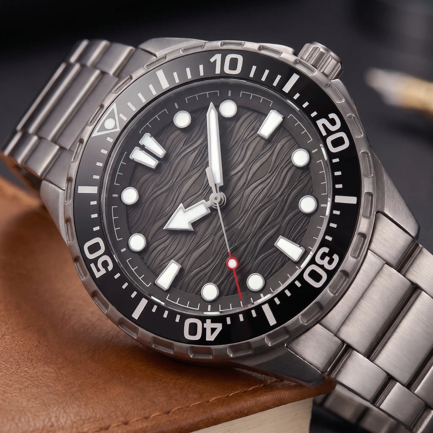 TITANIUM DIVE WATCH dial close-up - wave-textured dial, glowing markers and numbered dive bezel