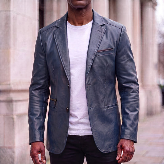 Navy blue men's leather-look two-button blazer with topstitched notch lapels, worn open over a white tee