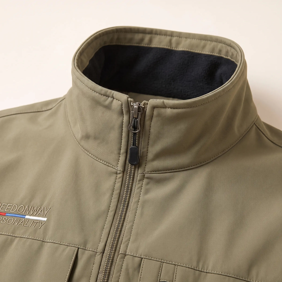 Close-up of the tall fleece-lined collar and the top of the front zip