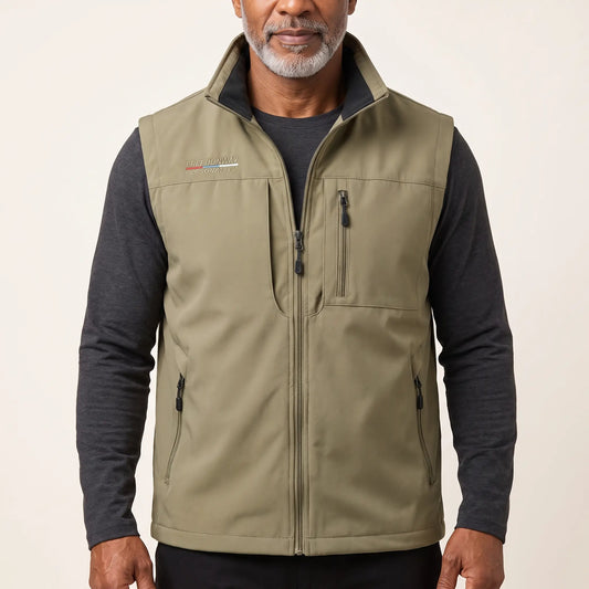 Man wearing the khaki zip-front outdoor vest over a charcoal long-sleeve top