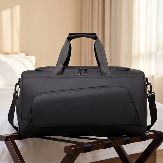 Transit gym duffel in black on a wooden luggage rack in a hotel room