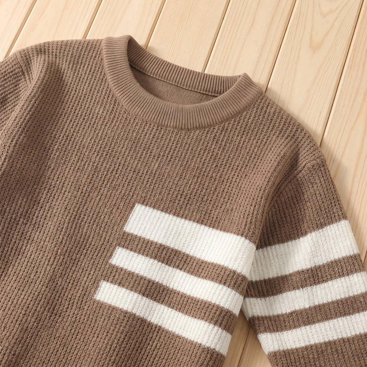 Close up of the TRIPLE STRIPE SWEATER ribbed crew neck and three chest stripes