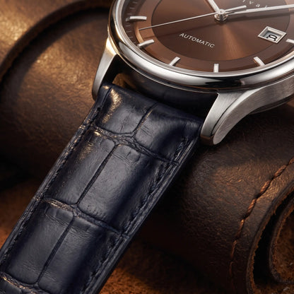 Close up of the navy croc embossed leather strap on the brown dial automatic watch