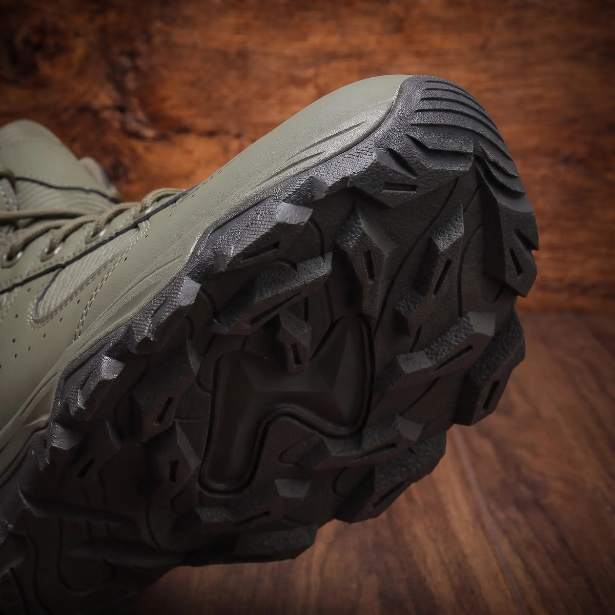Close up of the VENTED HIKING BOOTS outsole showing the deep multi directional lug tread