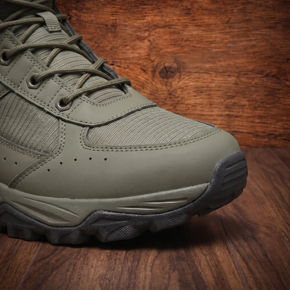 Close up of the VENTED HIKING BOOTS toe showing the ripstop panel, vent holes and rubber toe bumper