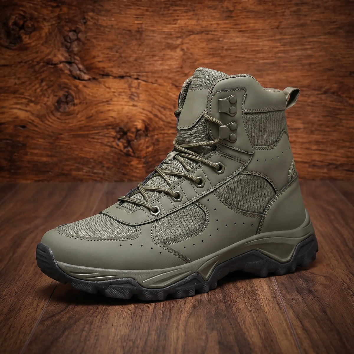 VENTED HIKING BOOTS in green, mid top hiking boot with vent holes and chunky lugged sole on a wood floor