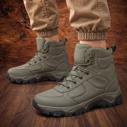 Man standing wearing the VENTED HIKING BOOTS with khaki cargo trousers on a wood floor