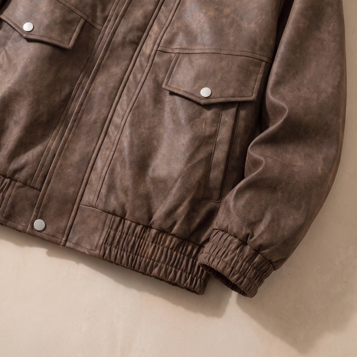 Flap pocket, elastic cuff and hem detail