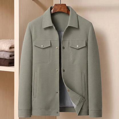 Sage green waffle texture shirt jacket on a wooden hanger in a pale wood wardrobe