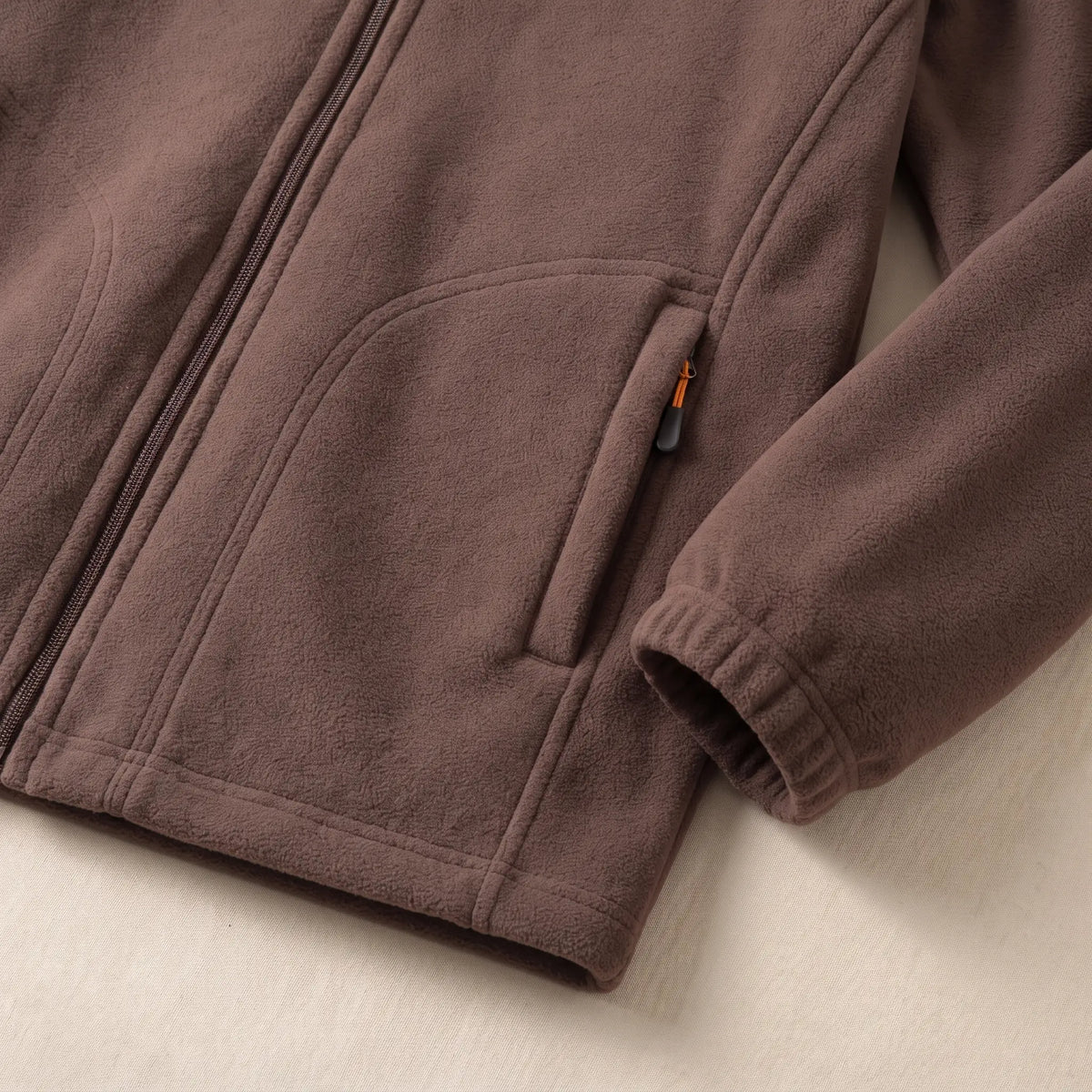 Close up of the WARM LINED FLEECE zip pocket and hem