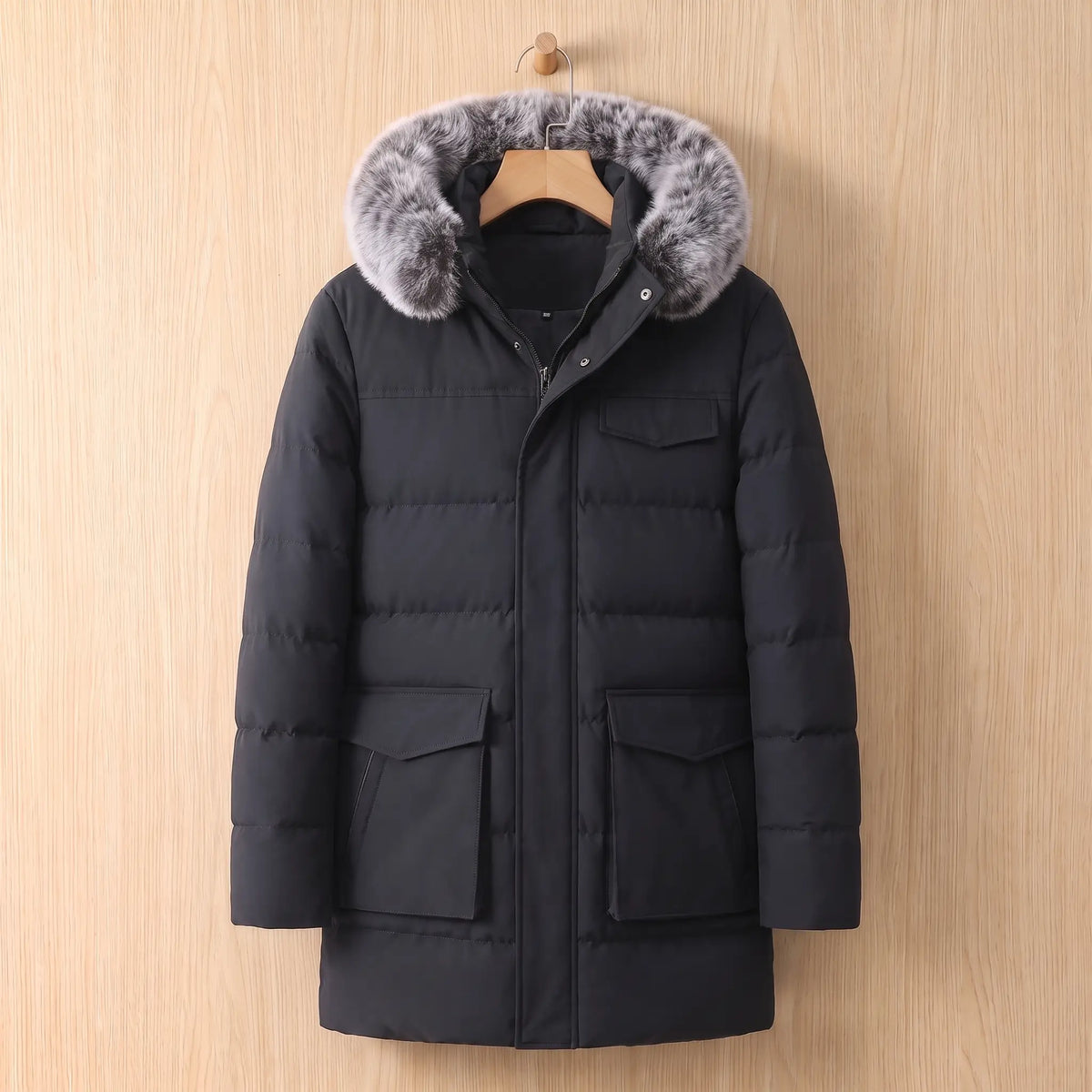Black warm longline parka for men with fur trimmed hood on a wooden hanger