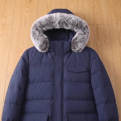 Flat lay of the fur trimmed hood and chest pocket on a navy blue warm longline parka for men