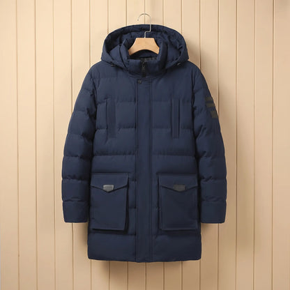 Men's navy blue quilted padded winter coat with hood, snap placket and large flap pockets on a wooden hanger